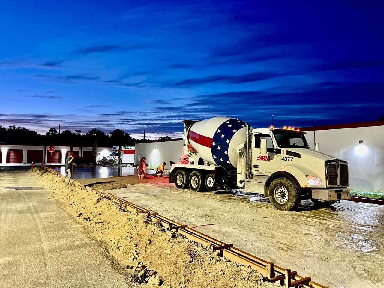 Photo of concrete truck pouring concrete foundation