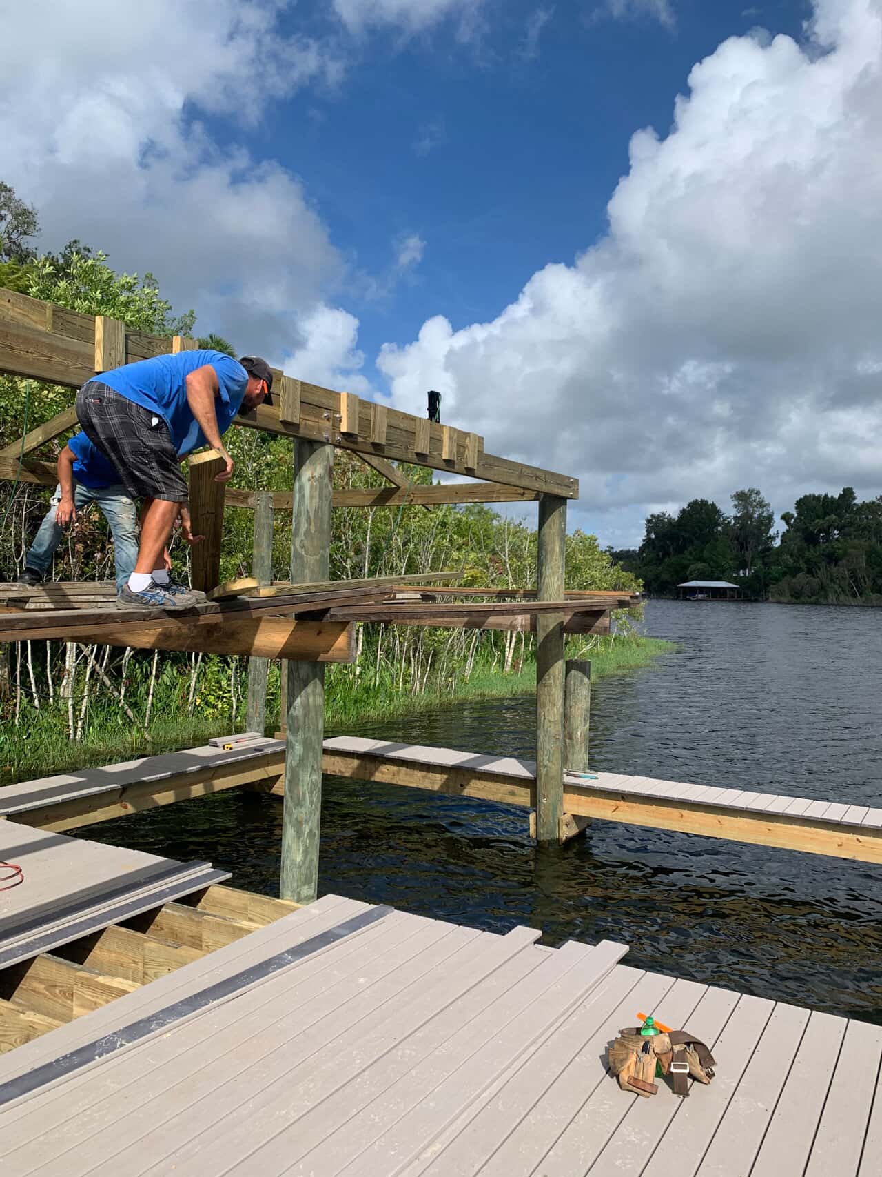 Photo of man installing a dock on the water